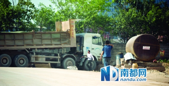 <p>    一名泥头车司机正在山寨加油站加油。</p>