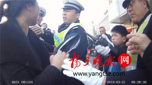 女子抡鞋抽交警 孩子劝“妈妈别动了”